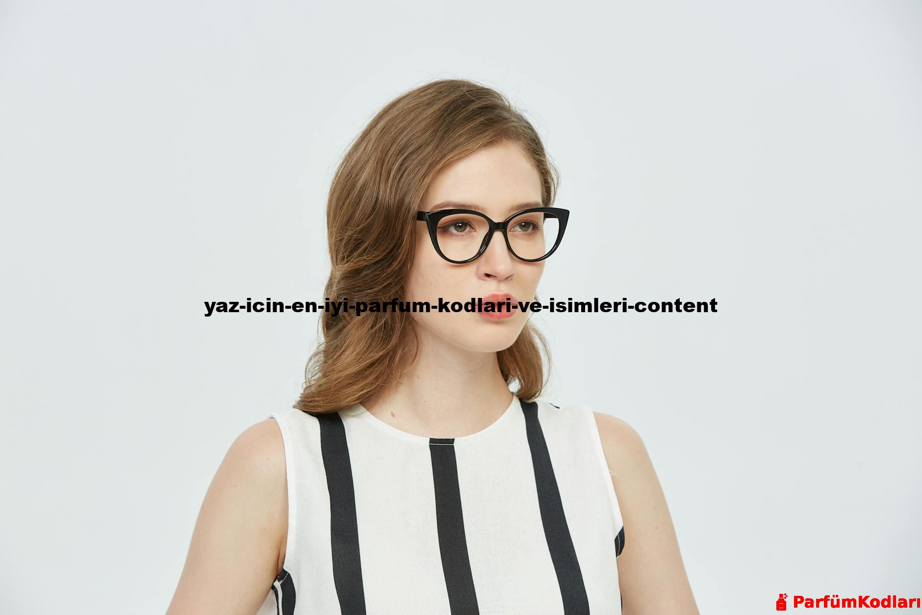 Portrait of a young woman wearing glasses, in a stylish striped dress, against a plain background.