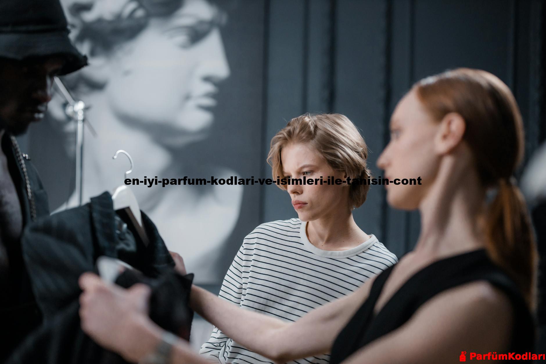 Fashion designers collaborate while reviewing a garment in a modern studio setting.