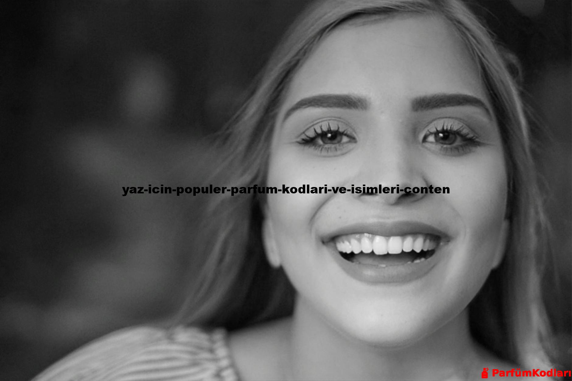 Close-up black and white portrait of a smiling woman looking directly at the camera.