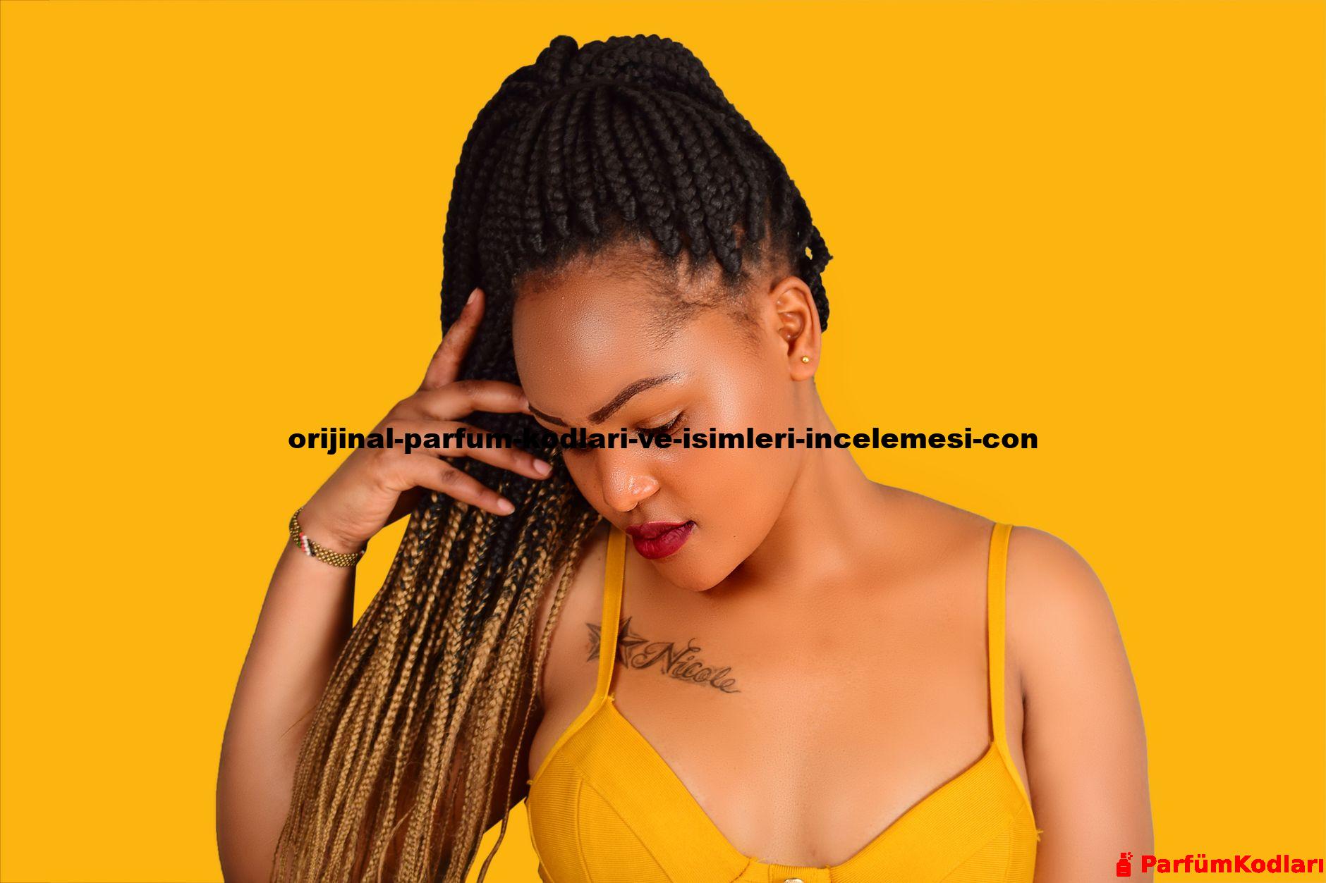 Fashionable African woman with afro braids looking down in studio shot.